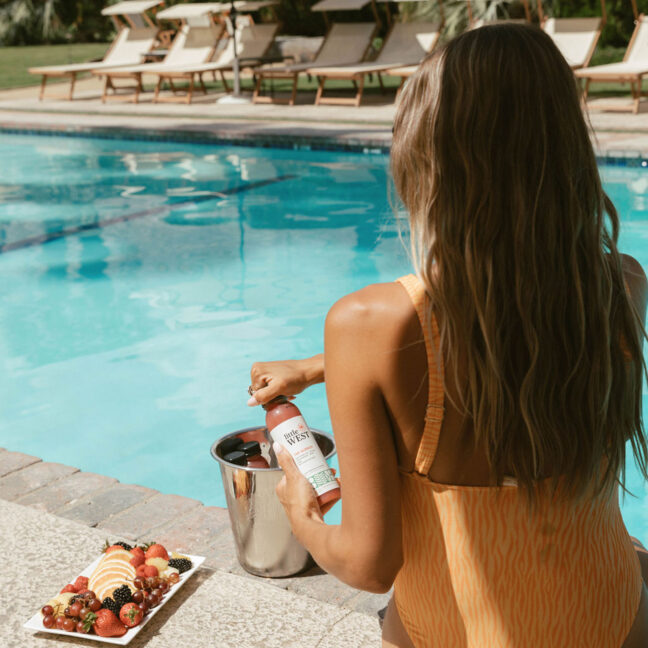 girl drinking rose by the pool