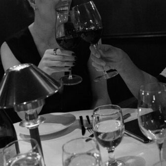 a girl smiling drinking wine